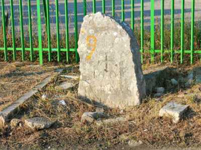 A Valenzano, un piccolo monolite cristianizzato davanti a una cancellata verde